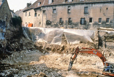 Vue générale du chantier de la rue de Vignier en cours de fouille. À l'arrière, s'élève l'hôtel Jouffroy, construit au XVe siècle, dont les fenêtres du rez-de-chaussée sont protégées par des grilles.